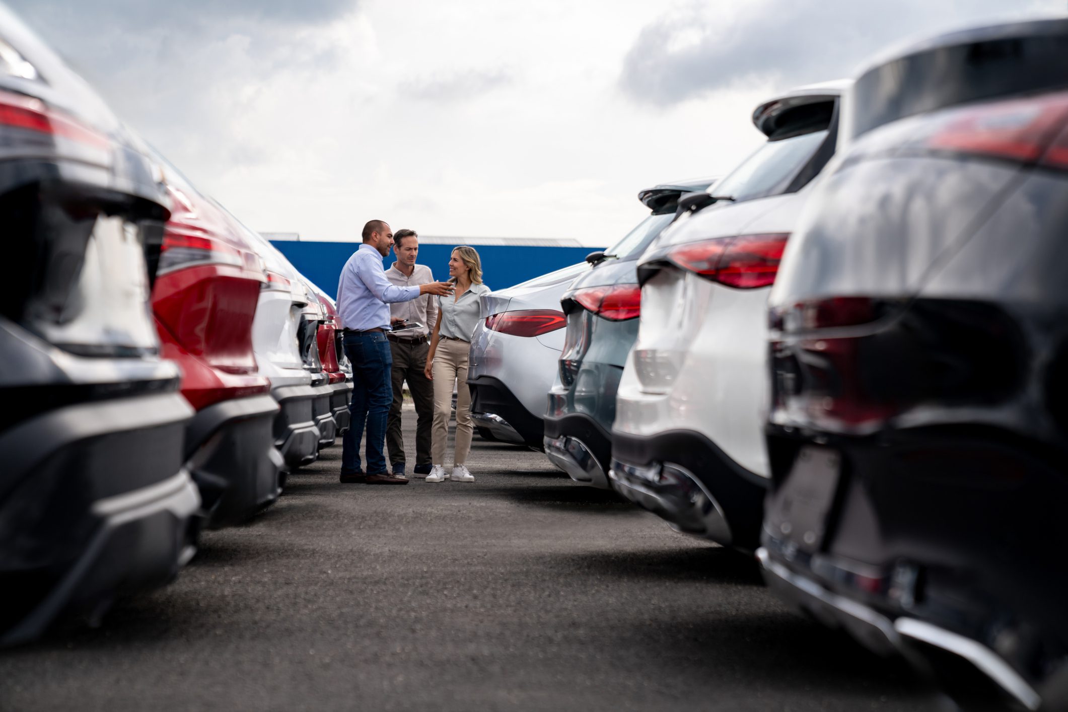 Car buyers discussing options at dealership